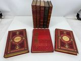 three books sitting on top of a white table next to each other