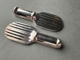 two metal spatulas sitting on top of a table