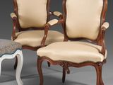 two chairs and a foot stool are sitting next to each other