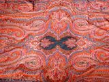 an image of an orange and blue paisley pattern on a bed