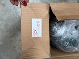 a person holding a box with a bunch of items inside of it