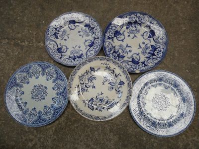 six assiettes bleues et blanches ornées de motifs floraux, posées sur une table