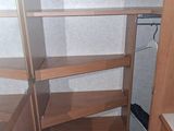 a closet with shelves and drawers in the corner