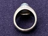 an image of a silver ring with a black stone in it