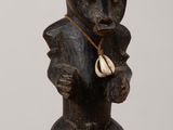 a wooden statue of a bear with a hat on it ' s head