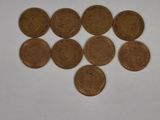 a lot of coins that are on a white surface