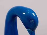 a blue bird figurine that is on a table