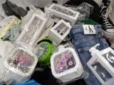 a pile of assorted items sitting on a bed