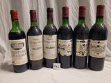 several bottles of wine are lined up on a table