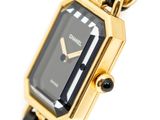 an image of a black and gold wrist watch with a chain around it