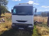 a white truck that is parked in the grass