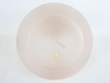 a pink plate with a yellow flower on it