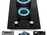 three burners on a black stove top with blue flames
