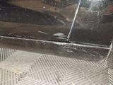 a close up of a car door with a hole in it