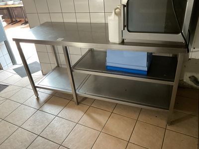 a microwave sitting on top of a table in a kitchen