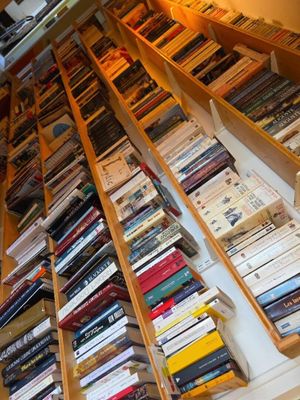 many books that are on the shelves in the room