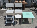 three chairs and a table on the ground