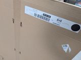 a cardboard box with a sticker on it sitting on the floor