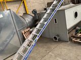 a ladder that is leaning against the wall next to a machine