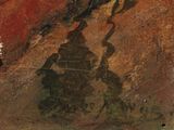 a painting of a man riding a horse on a rock