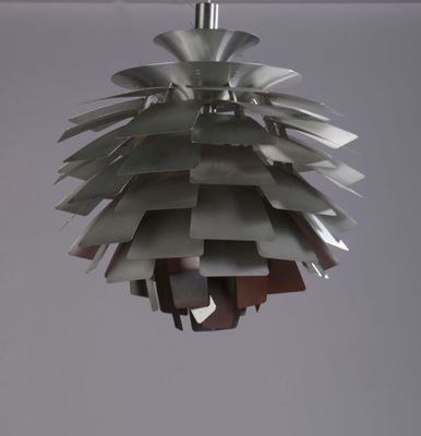 a metal light hanging from a ceiling in a room