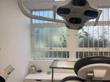 a dentist ' s chair in the corner of the room