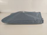 a blue bag sitting on a table with a white background