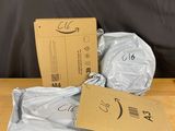 three bags of toilet paper sitting on a wooden table