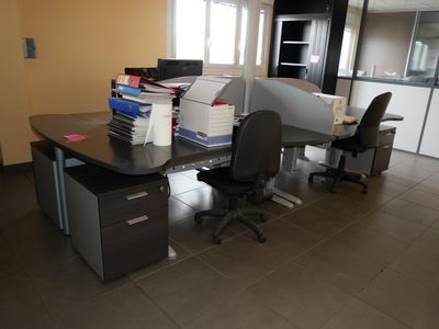 a desk with two chairs and a computer on it