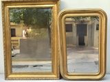 two mirrors sitting next to each other on a table