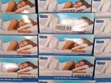 several boxes of pillows stacked on top of each other in a store