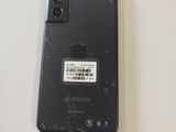 a black cell phone with a sticker on the back of it