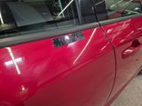 a red car with a sticker on the side of it