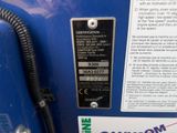 a close up of a blue machine with a label on it