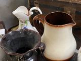 many different types of vases and bowls on the table