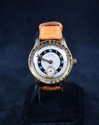 gros plan d'une montre sur un support sur une surface noire