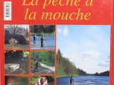 a red book with pictures of people fishing in the water
