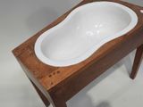 a wooden table with a white bath tub on it