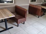 two tables and a bench in the corner of a restaurant