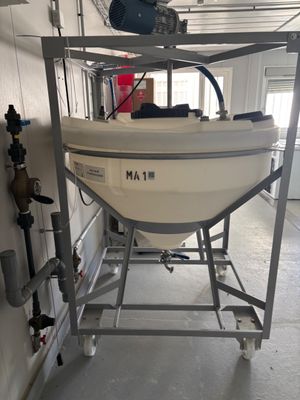 a boat that is sitting on a stand in a garage