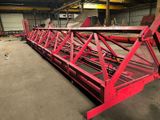 a red crane that is sitting in a warehouse