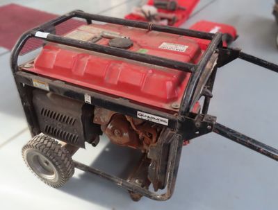 a small red engine on a cart on the floor