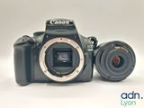a camera and a lens sitting next to each other