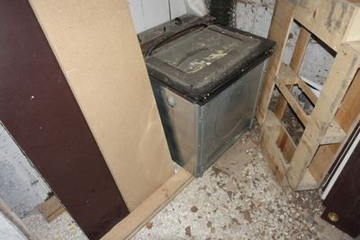 une machine à laver et un sèche-linge sales, dans un coin de la pièce