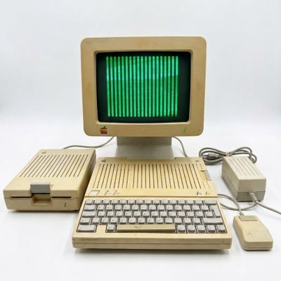 an old computer with a green screen and keyboard