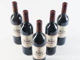 four bottles of wine are lined up in a row