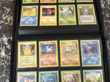a lot of pokemon cards in the case on the table