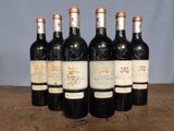 six bottles of wine sitting on top of a wooden table