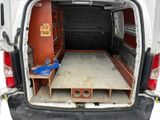 a white van with a bed in the back of it
