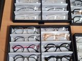 several pairs of glasses are in a black case on a table